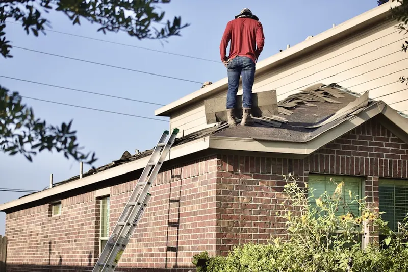 Professional roofer working on a residential roof in Wilson Corners